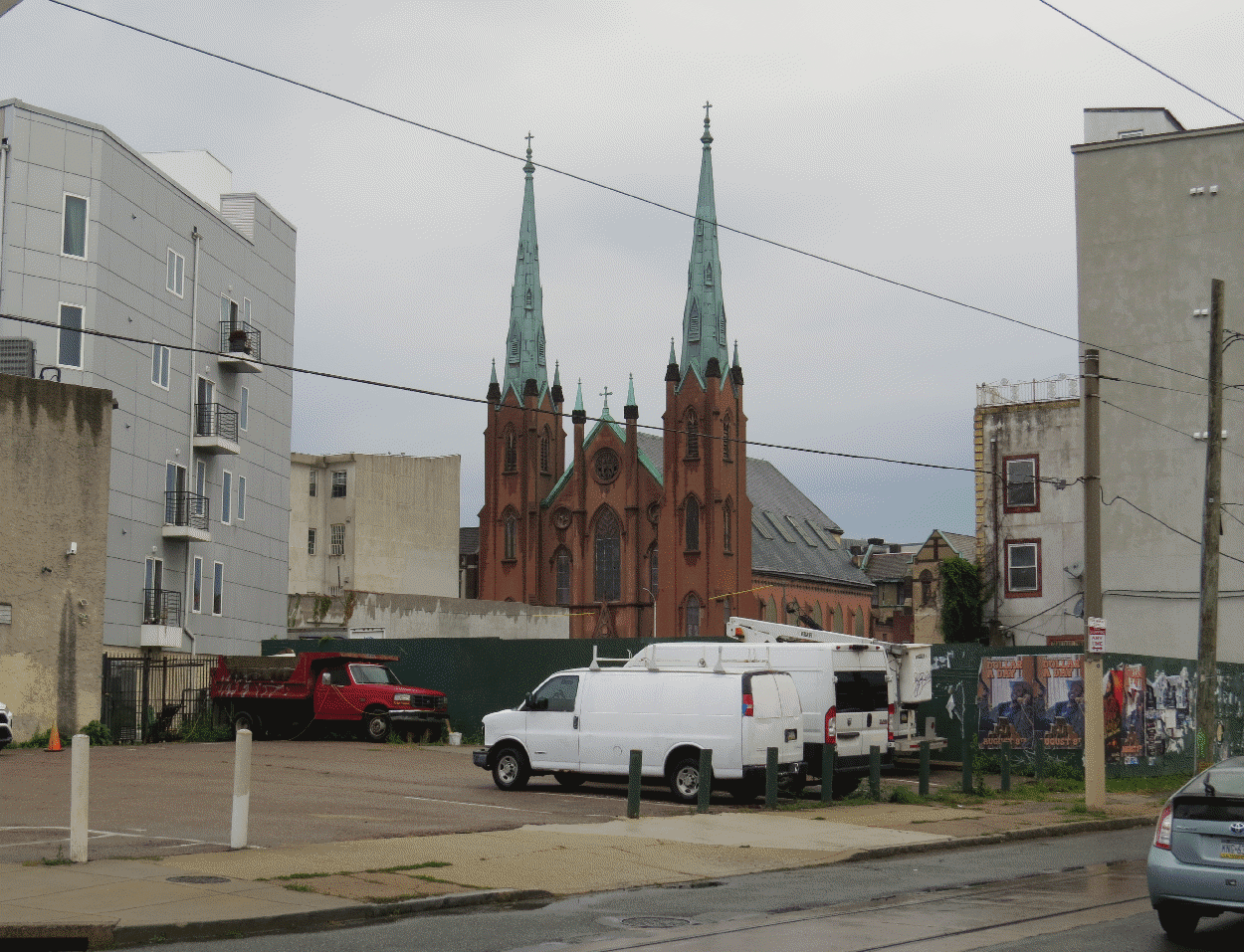A church in the near distance, with a small parking lot slightly obscuring the view.