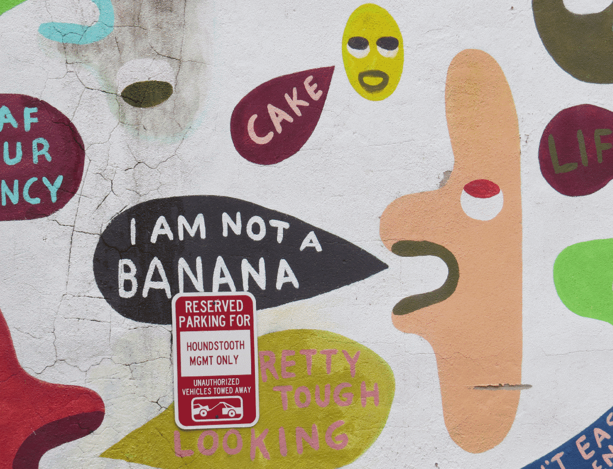 Street art of an abstract creatures saying random things.